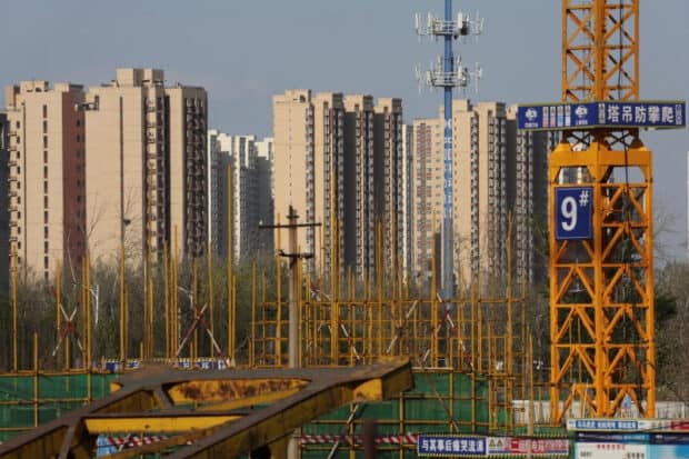 Residential buildings are pictured near a construction site in Beijing, China April 14, 2022.  REUTERS/Tingshu Wang/File photo