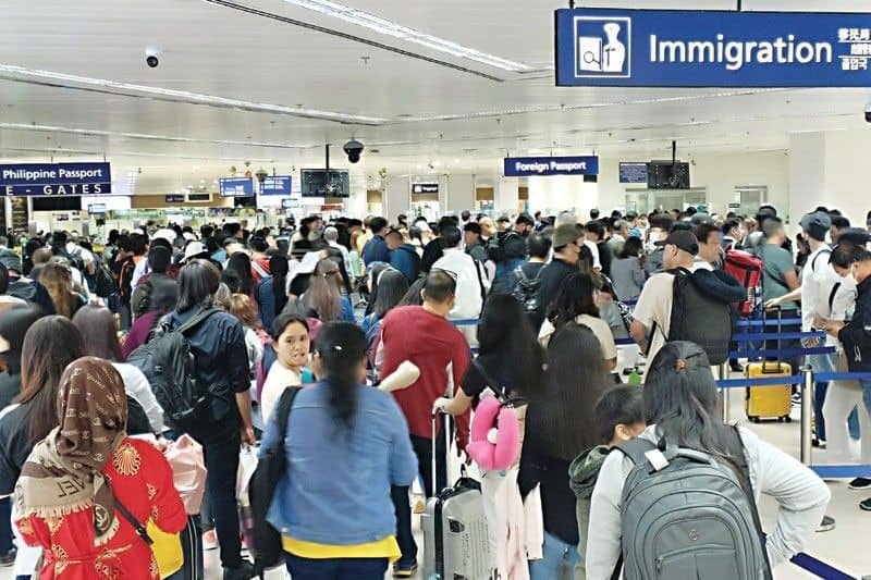 Passengers wait in line at the immigration area as the Ninoy Aquino International Airport Terminal 3 services more international flight departures and arrivals.
