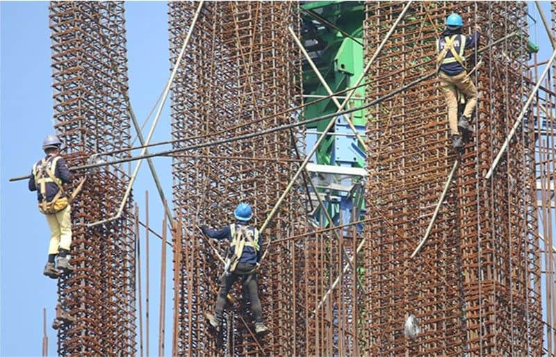 Workers continue to operate at a construction site in Santa Cruz, Manila on October 26, 2023.
