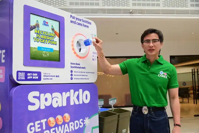 RECYCLING MADE EASY SM Supermalls President Steven Tan tests the Sparklo reverse vending machine, underscoring SM’s commitment to empowering communities to build everyday recycling habits. PHOTO FROM SM

