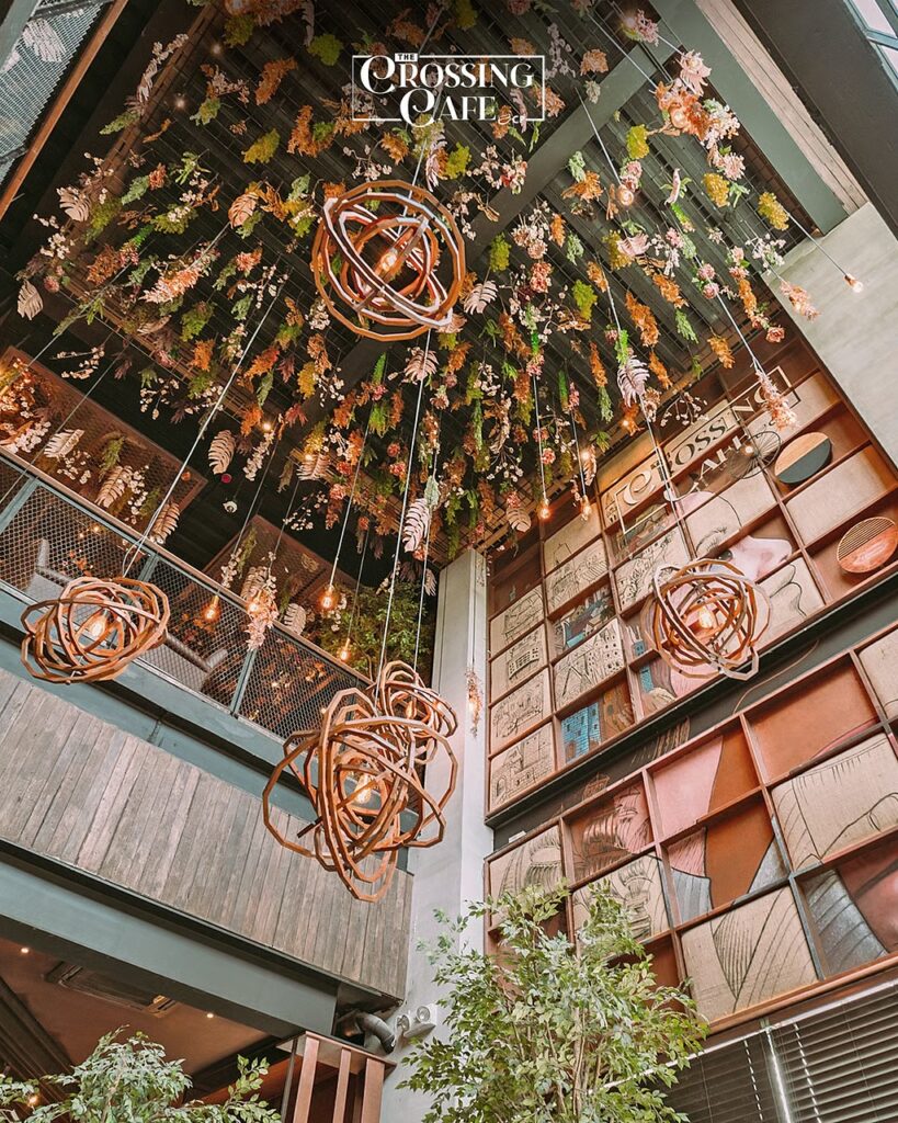 FLORAL ceiling installations with lounge-style tables.