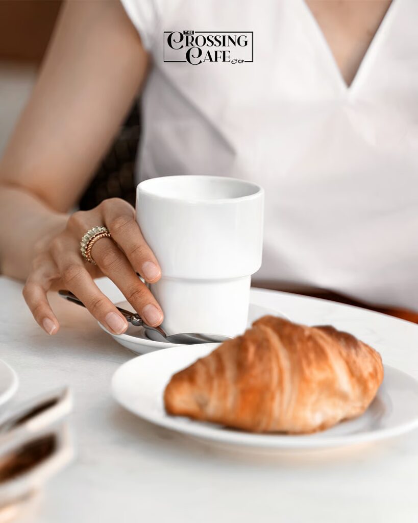A warm cup of  coffee paired with a rich tasting croissant to start the day.